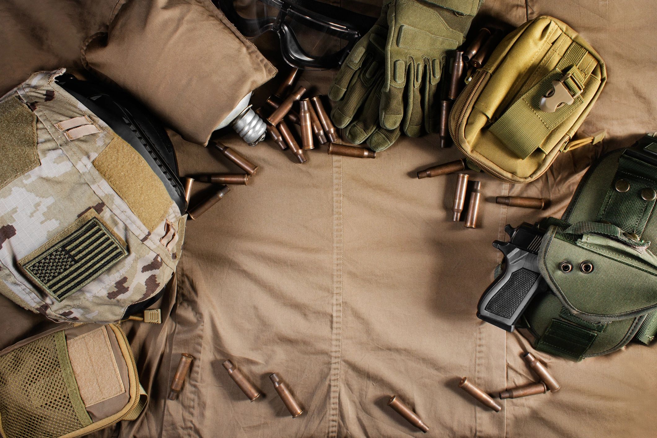 Military-style gloves and helmet arranged with gear